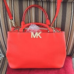 Michael Kors Orange & Gold Handbag. Pre-owned Good Condition Still w/ sales tag.